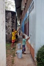 Asian group are painting on the wall.